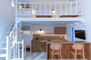 a loft conversions kitchen and dining room with a staircase at Andromeda Residence in Mikonos