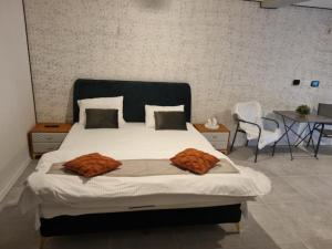 a bedroom with a large bed and a table at Georgiana Apartments 2 in Timişoara