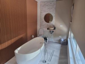a bathroom with a white tub and a sink at Georgiana Apartments 2 in Timişoara