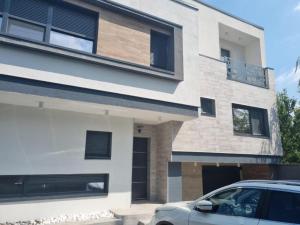 a house with a car parked in front of it at Georgiana Apartments 2 in Timişoara