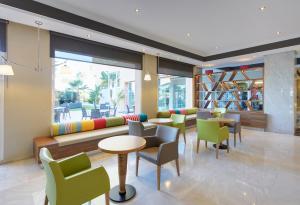 
a living room filled with furniture and a large window at Sol Guadalmar in Málaga
