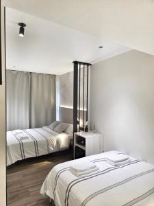 a bedroom with two beds and a table in it at Pension Oasis Alicante in Alicante +54 photos