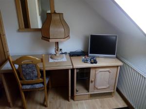 a desk with a computer and a laptop on it at Landhotel Eichenkrug in Groß Breese
