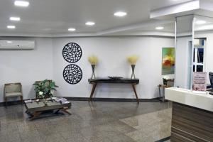 a lobby with a table and some vases on the wall at Hotel Serra de Jundiaí in Jundiaí +72 photos