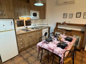 a kitchen with a table with a table cloth on it at Vivienda Chorrillos del Lavadero in La Iruela