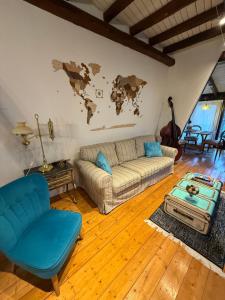 a living room with a couch and a map on the wall at Gemütliches Scheunenfachwerkhaus nahe Frankfurt mit Glasfaser und Klima in Bad Soden am Taunus