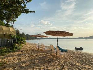 a group of chairs and umbrellas on a beach at Moonshine Phayam beach resort & restaurant in Ranong +18 photos