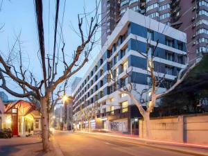 a building on a city street at night at base-WENDING Service Apartment-Shanghai Xujiahui Location in Shanghai