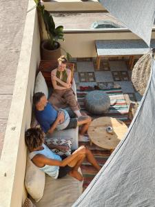 three people sitting on the floor of a tent at Cool Surfers Morocco in Agadir