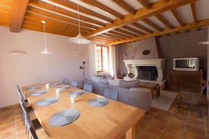 a dining room with a table and a couch at Clos Du Père Clément in Visan