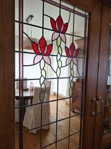 a stained glass door with three flowers on it at Villa Bonifica in Riemst