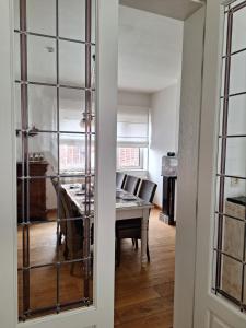 a room with a table and a dining room at Villa Bonifica in Riemst