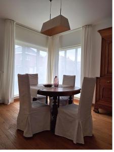 a dining room with a table and chairs at Villa Bonifica in Riemst +19 photos