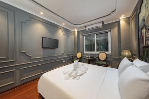 Ένα ή περισσότερα κρεβάτια σε δωμάτιο στο The MaxWell Hanoi Hotel