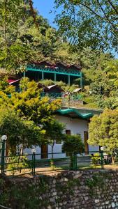 a building with a green roof on top of a hill at Maasa Retreat & Resort in Shivpuri