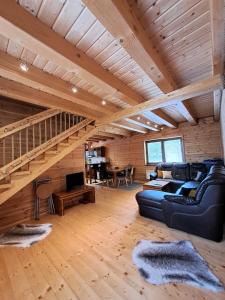 a living room with a couch and a staircase at Chatô Liptov in Liptovský Mikuláš