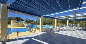 a rendering of a swimming pool with a blue roof at Minerva 211 - 24h reception - 1 bedroom in Benalmádena