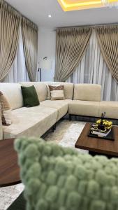 a living room with a couch and a table at Amik Homes in Aso