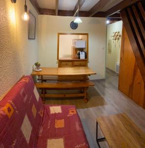 a living room with a wooden table and a couch at Appartement Barèges centre du village in Barèges