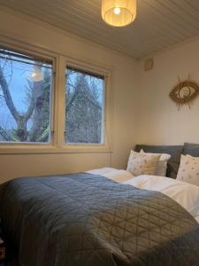 a bedroom with two beds and a window at Sofias Lovely Little House in Stockholm
