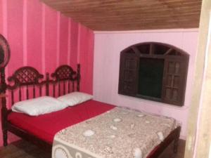 Ein Bett oder Betten in einem Zimmer der Unterkunft Recanto da Kaká