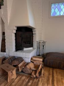 a living room with a fireplace and a bed at Sofias Lovely Little House in Stockholm