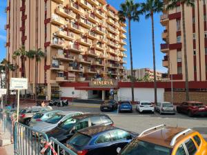 a parking lot with cars parked in front of a building at Minerva 211 - 24h reception - 1 bedroom in Benalmádena