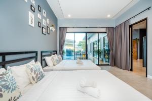 Giường trong phòng chung tại Lom-Talay poolvilla huahin +53 ảnh