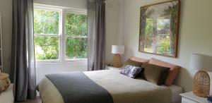 a bedroom with a bed and a window at Kipsie Cottage - Point Lonsdale in Point Lonsdale +12 photos