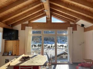 a kitchen with a large window with a view at Chesa Tre Piz in Maloja