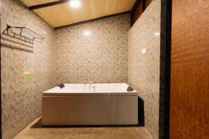 a bathroom with a white sink in a room at Discovery Village Kabini in Antarasante +23 photos