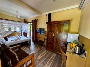 a room with a bed and a living room at WILD PARADISE Apt in Unawatuna