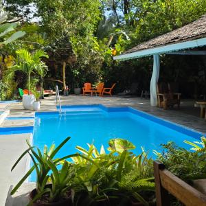 a swimming pool in the yard of a villa at La Rana De Cahuita in Cahuita