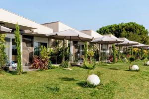 een gebouw met parasols in een tuin bij Amadeus Golden Resort in Toroni