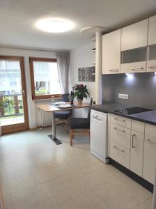 a kitchen with a table and a dining room at Ferienwohnungen Pircher in Rablà