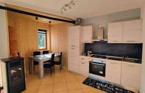 a kitchen with a table and a stove and a dining room at Casa Producena in Valdidentro