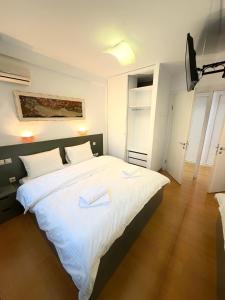 ein Schlafzimmer mit einem großen Bett mit zwei Handtüchern darauf in der Unterkunft Premium Seafront Suite in Thessaloniki