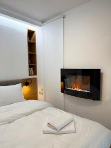 a bedroom with a bed with a fireplace on the wall at Premium Seafront Suite in Thessaloniki +13 photos