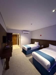Postel nebo postele na pokoji v ubytování Durrat AlJawharah Hotel Makkah