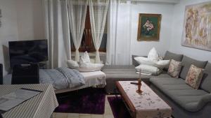 a living room with a couch and a table at La Suite in Baden-Baden