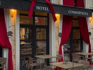 a restaurant with tables and red drapes in front at Cosmopolita Boutique Hotel in Timişoara