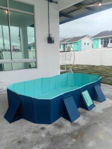 a blue ping pong table in front of a building at SWee Garden Homestay in Kota Tinggi