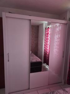 a sliding glass door with a bed in a room at Apartamento Inteiro Foz do Iguaçu Prox Rodoviaria in Foz do Iguaçu +15 photos