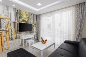 a living room with a couch and a tv at Villa Jakov Apartments II in Promajna