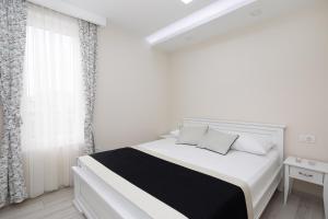 a white bedroom with a white bed and a window at Villa Jakov Apartments II in Promajna