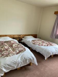 En eller flere senge i et værelse på Resort Inn Seikan