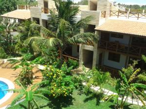 an aerial view of a resort with a pool and trees at Serrote Breezes Apartamento 04 in Jericoacoara