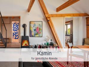 a living room with white walls and wooden beams at Landloft Linum in Fehrbellin
