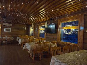 a dining room with tables and chairs and a television at Kaamasen Kievari in Kaamanen +56 photos