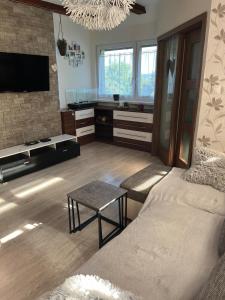 a living room with a bed and a tv at Dom pre hostí blízko centra BB in Banská Bystrica